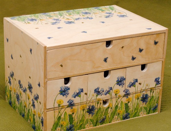 Decoupaged chest of drawing.