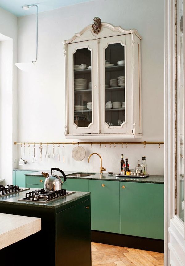 Kitchen with green and cream cabinets
